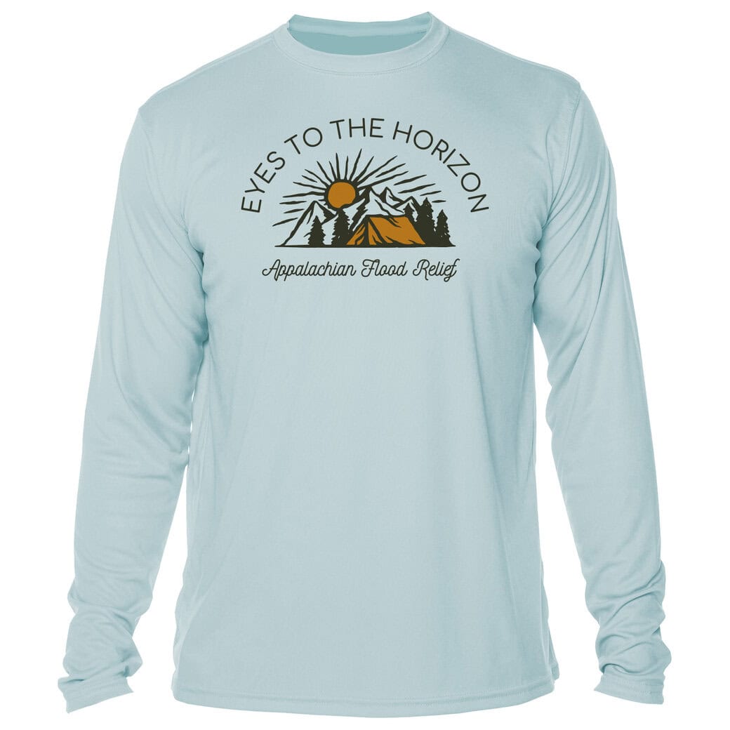 Sunrise over mountains with trees on a long sleeve shirt.